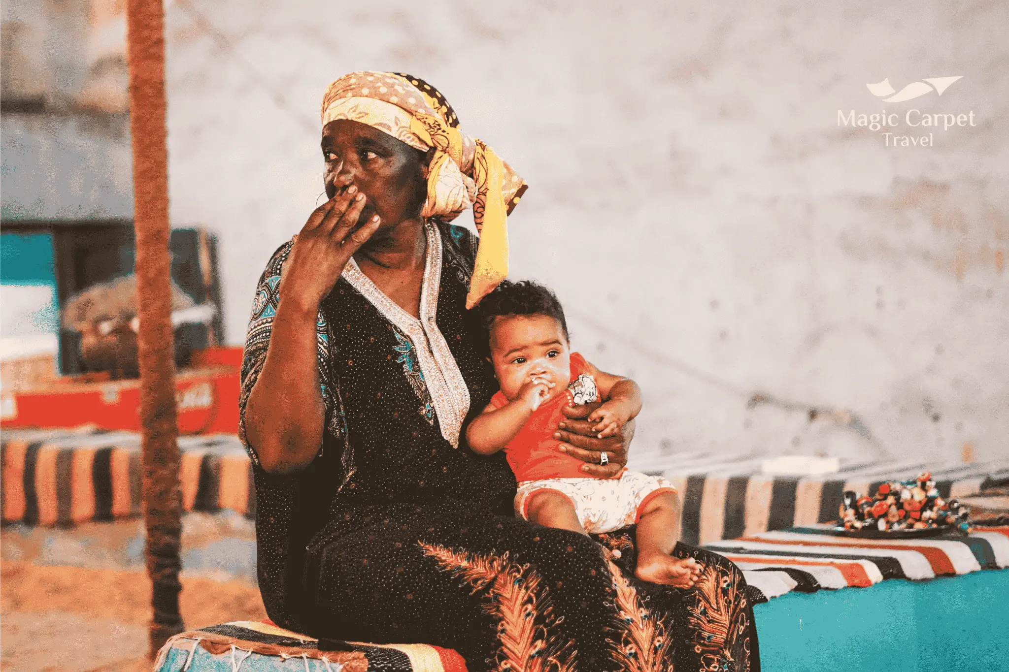 Traditional Nubian culture in Egypt with colorful houses, local crafts, and people in traditional dress along the Nile